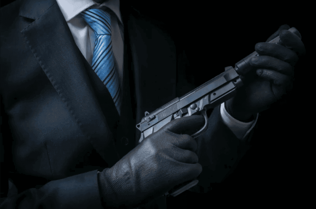 a Hitman holding a loaded pistol.